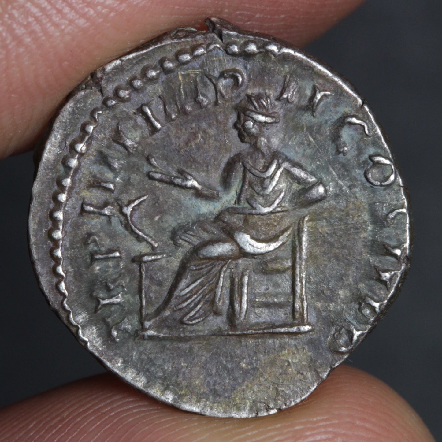 commodus denarius reverse side, showing salus seated and feeding snake