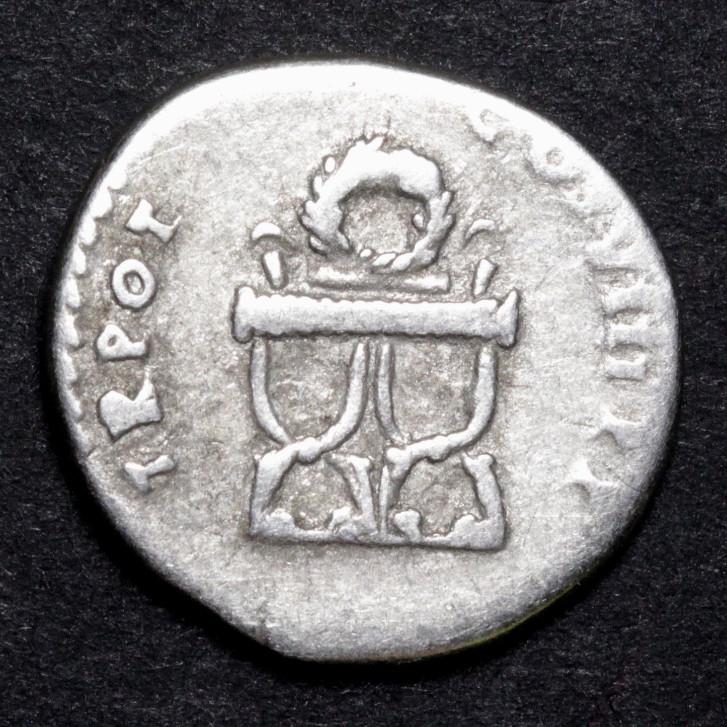ancient roman coin showing a chair on the reverse side
