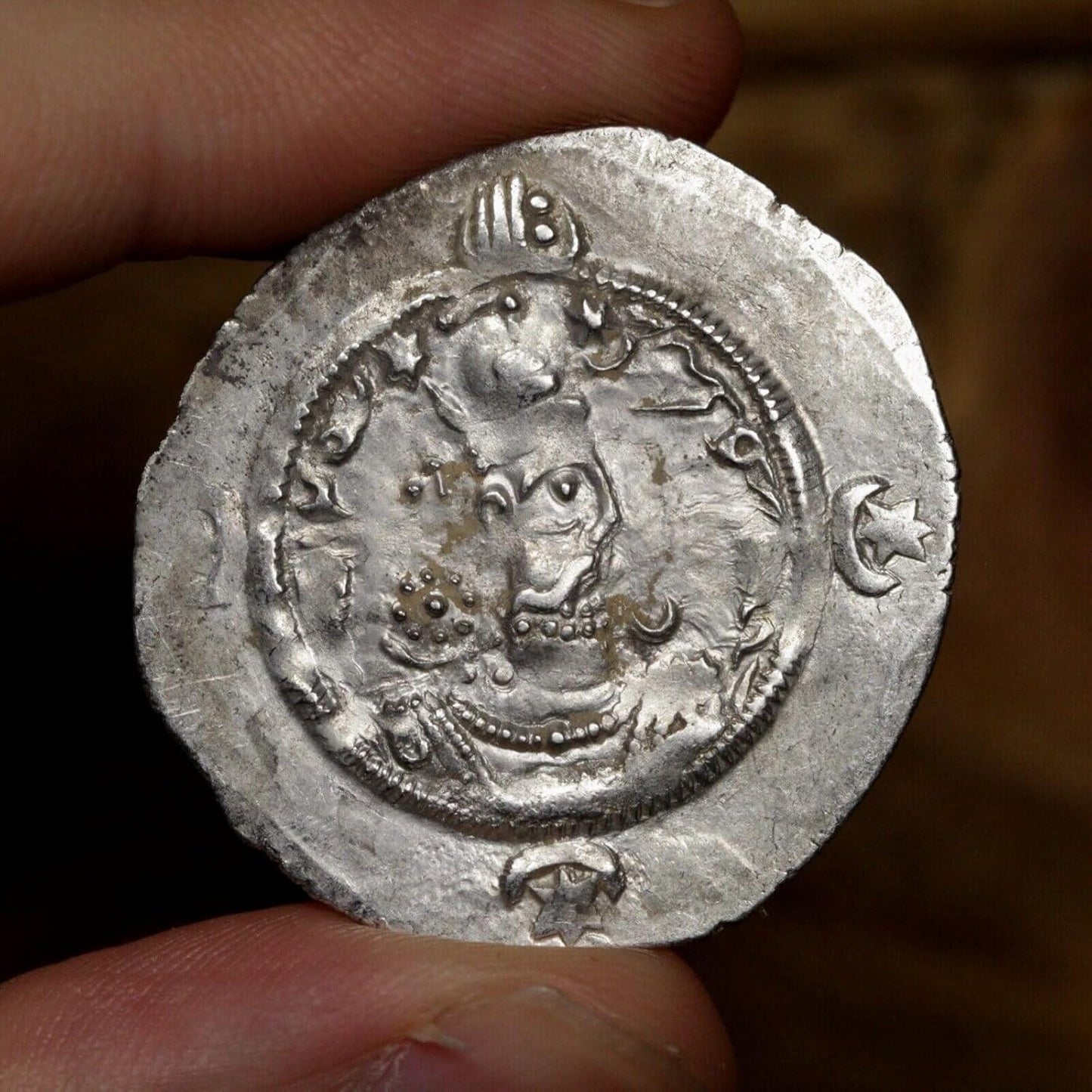 the front side of a sasanian silver drachm coin showing the portrait of a sasanian king