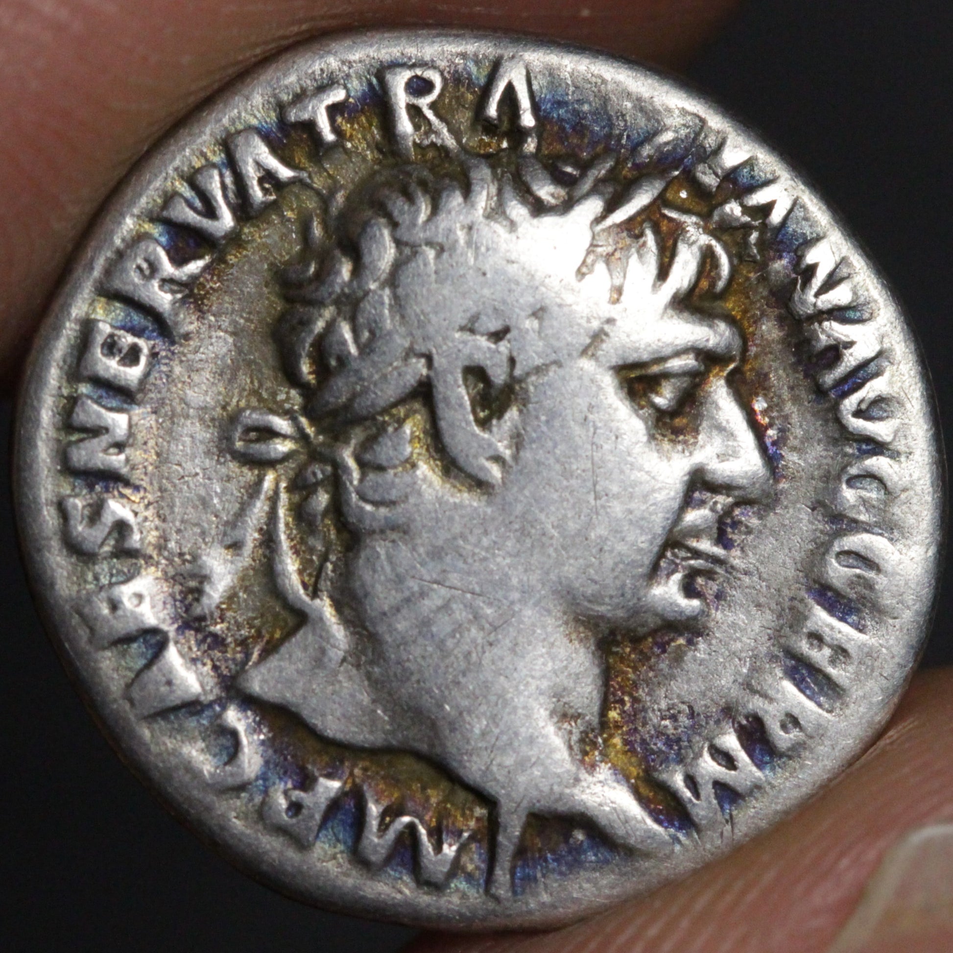 Ancient Roman silver coin with profile of a emperor and inscriptions