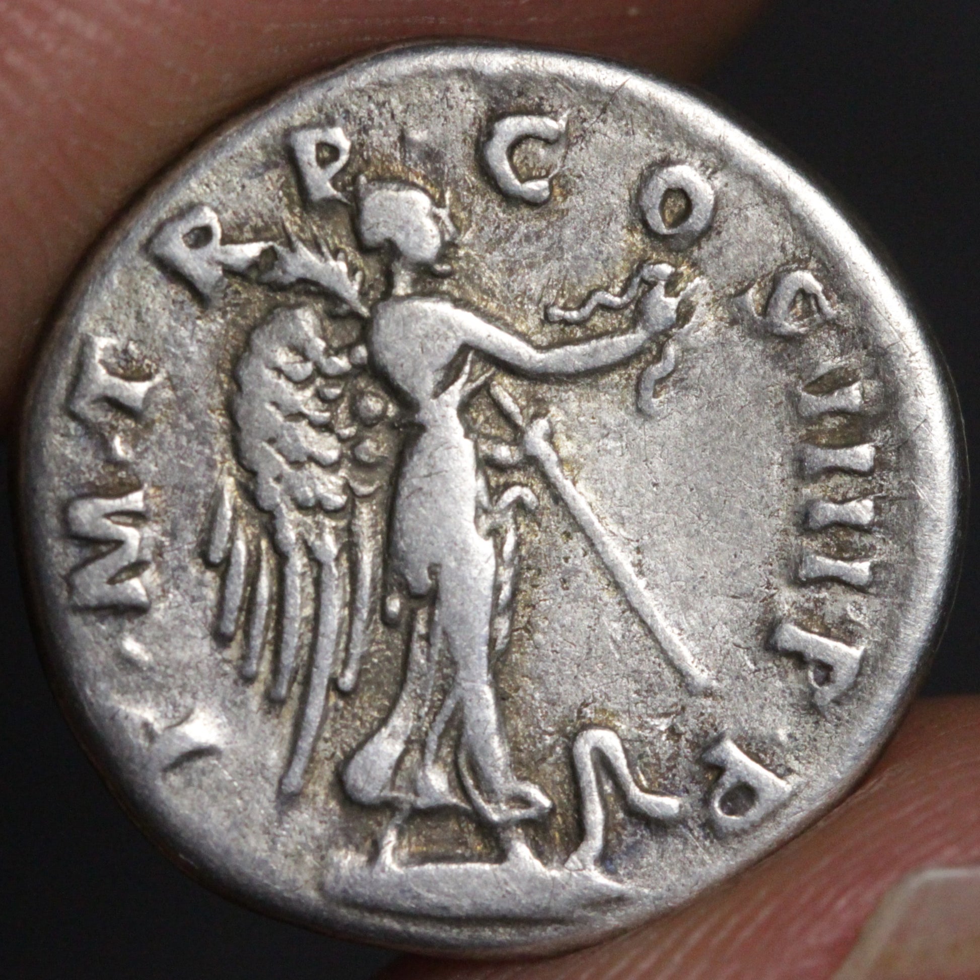 Ancient silver coin with angelic figure and inscriptions