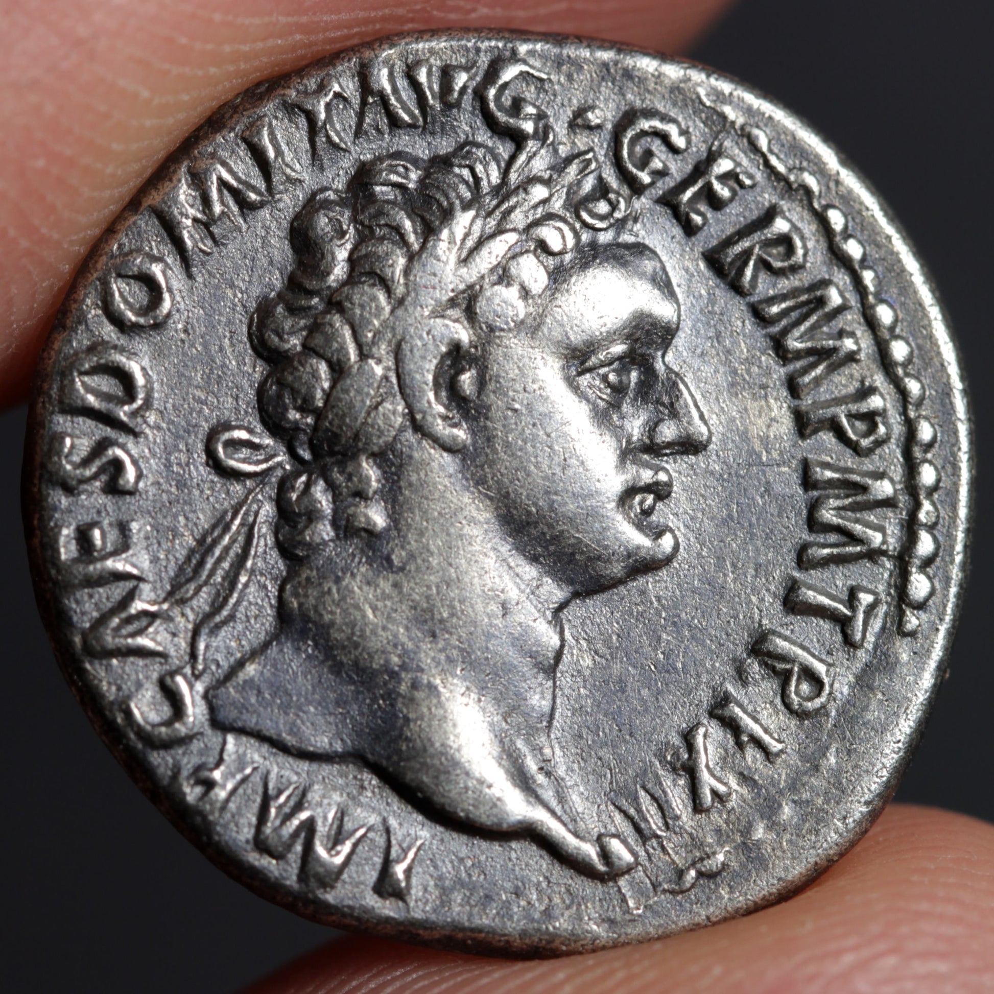 obverse side of domitian denarius showing portrait of domitian
