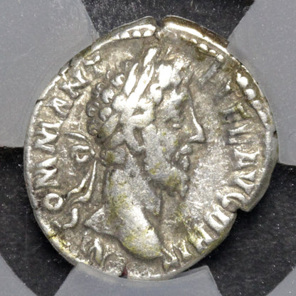 Ancient Roman silver coin with a profile of a emperor on a gray background