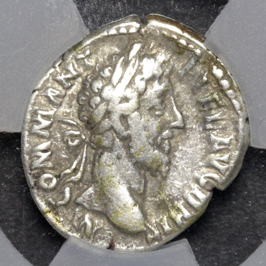 Ancient Roman silver coin with a profile of a emperor on a gray background