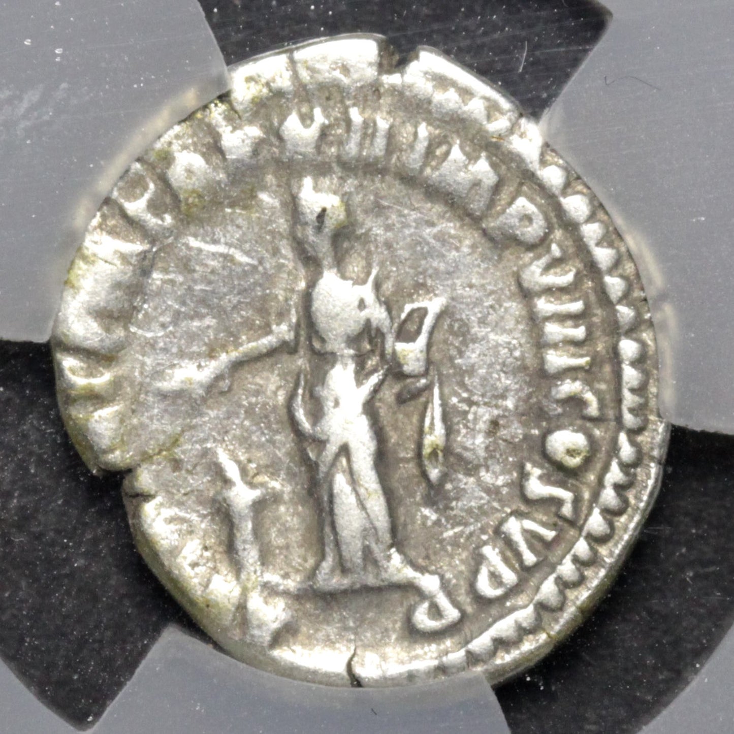 Ancient silver coin with a figure and inscriptions on a gray background