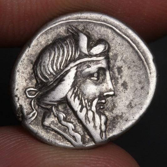 Ancient coin with a portrait on a dark background