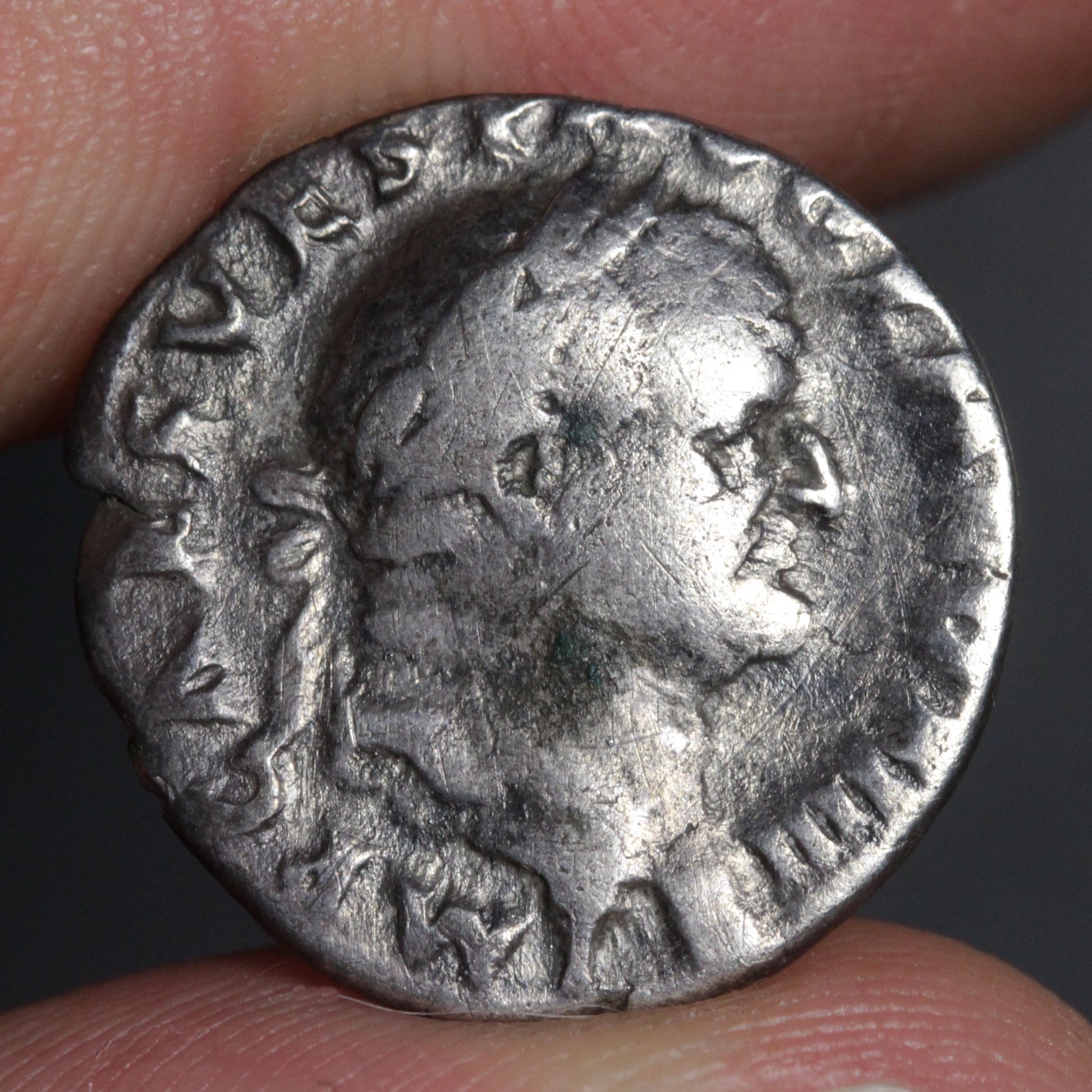 vespasian denarius being held being two fingers