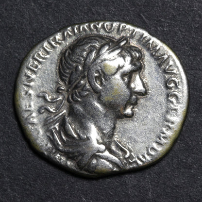 Ancient Roman coin with profile of a emperor on a dark background