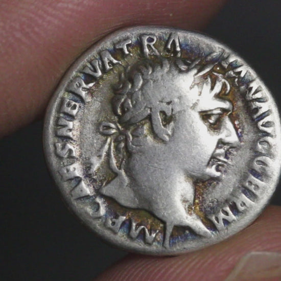 video of ancient Roman silver coin of trajan rotated to show both sides