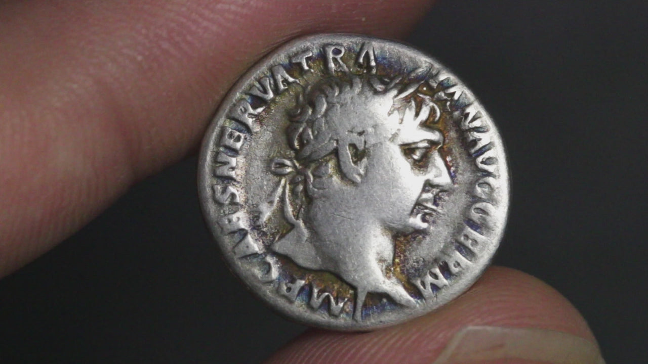video of ancient Roman silver coin of trajan rotated to show both sides