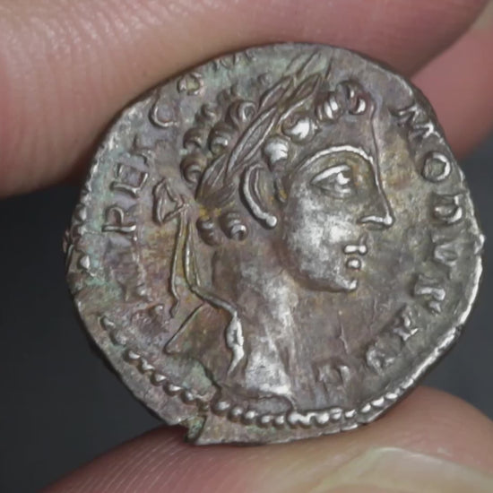 video showing commodus denarius being rotated between two fingers to display both sides