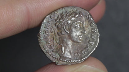 video showing commodus denarius being rotated between two fingers to display both sides