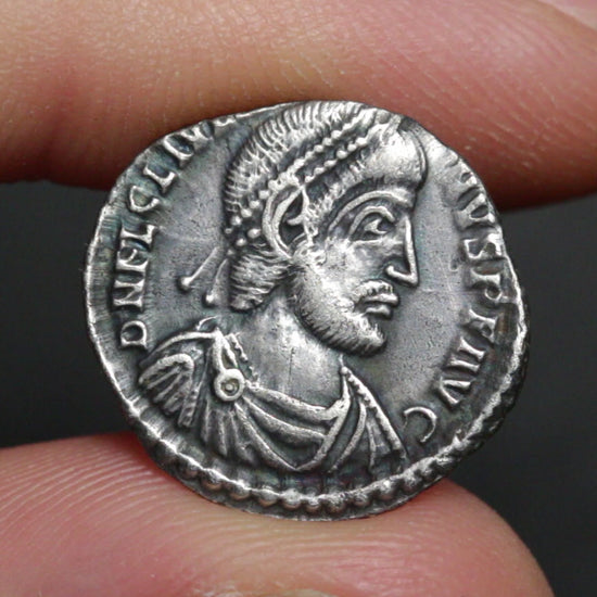video of julian the apostate siliqua held between two fingers being rotated to show both sides