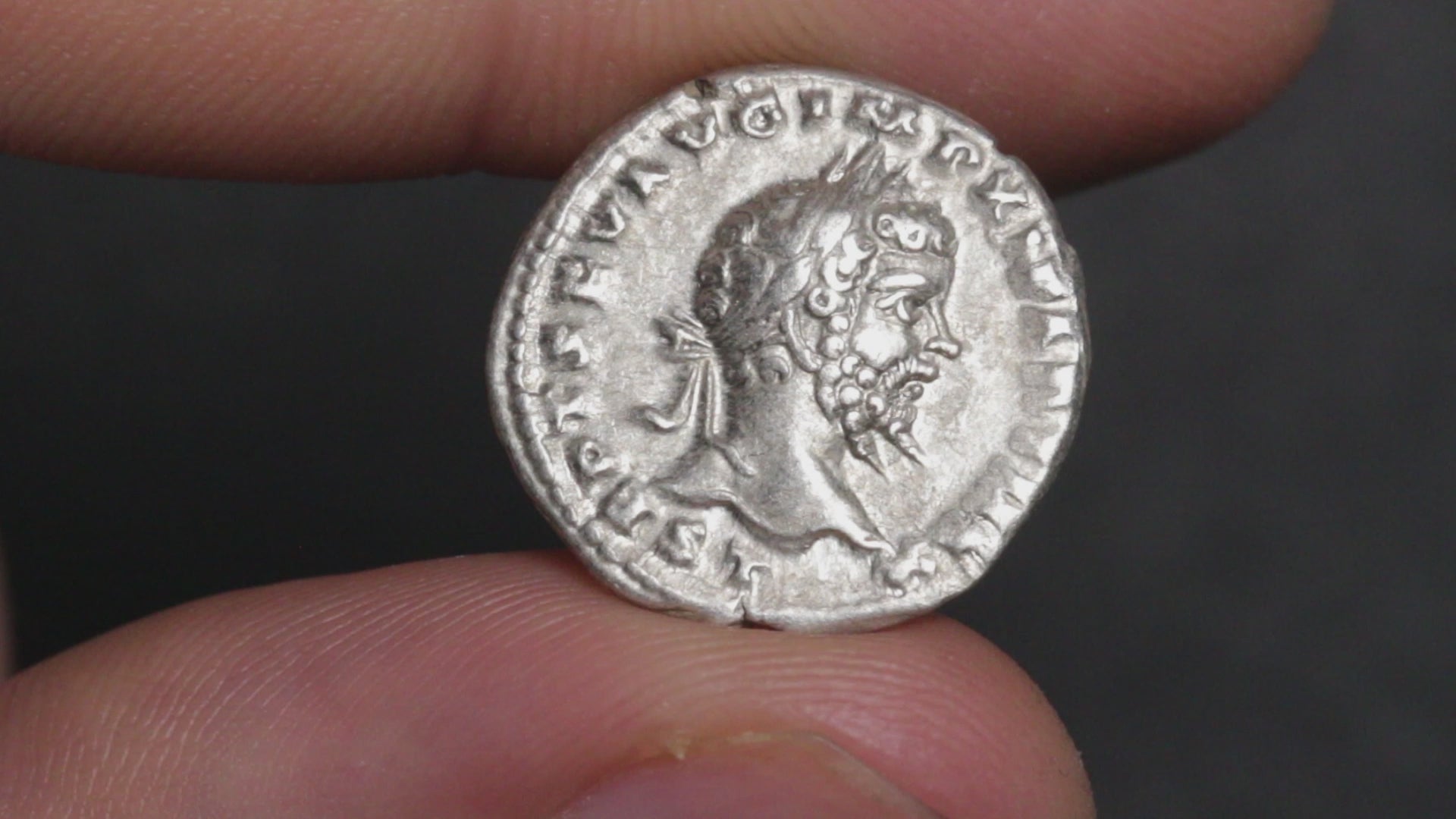 video of septimius severus denarius being rotated betwen two fingers to show both sides