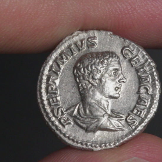 video of an ancient silver coin being rotated between two fingers to show both sides
