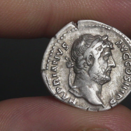 video of hadrian denarius being rotated between two fingers to show both sides