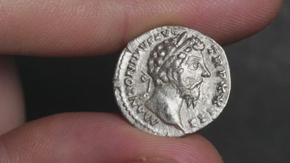 video of marcus aurelius denarius being rotated between two fingers to show both sides