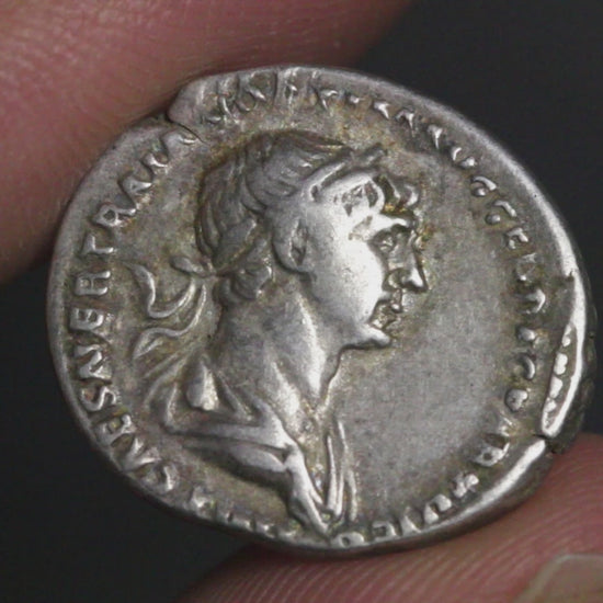 video of trajan denarius being rotated in hand to show both sides
