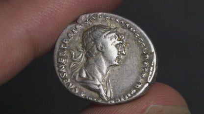 video of trajan denarius being rotated in hand to show both sides