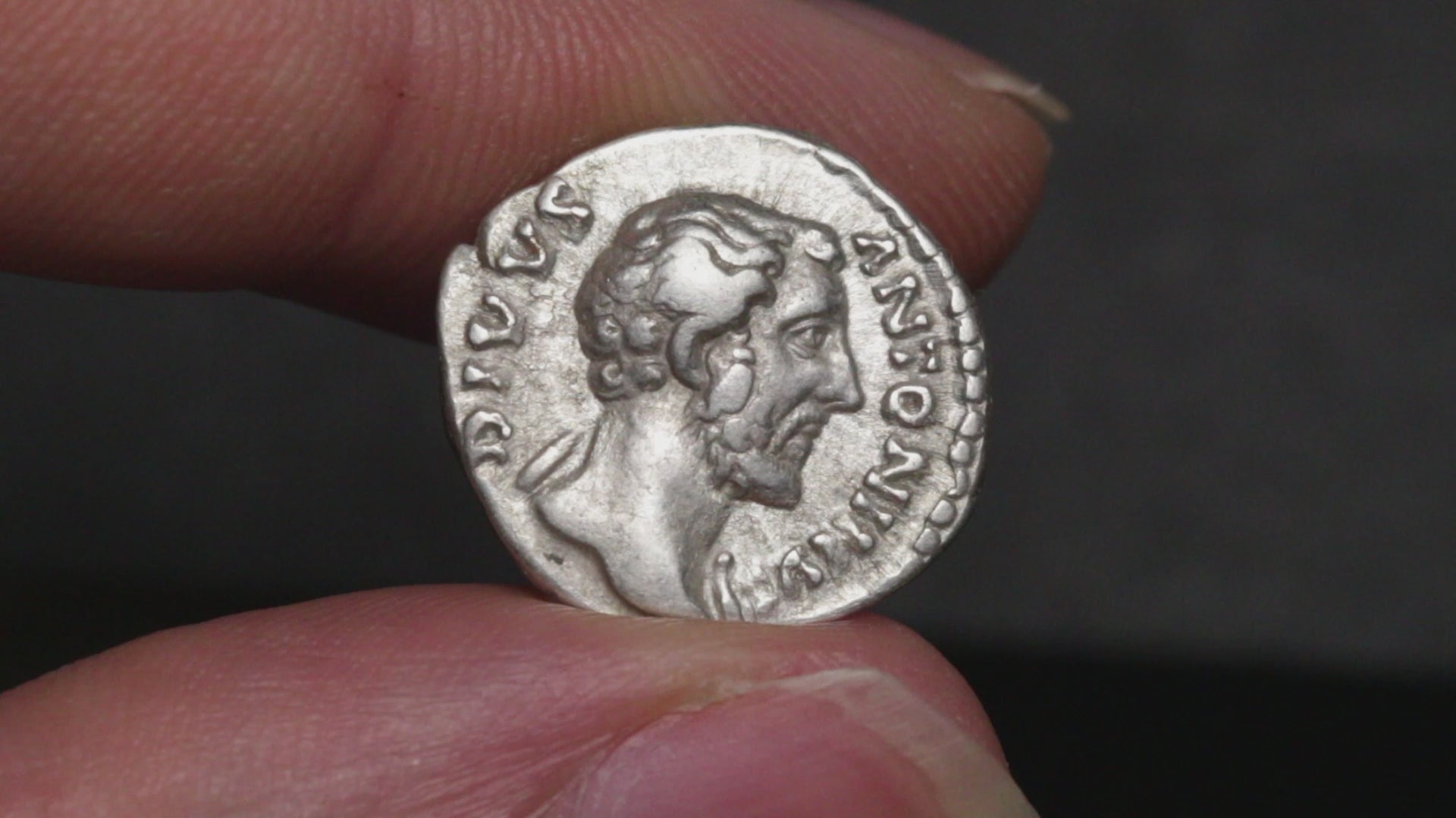 video of antoninus pius denarius being rotated between two fingers to show both sides