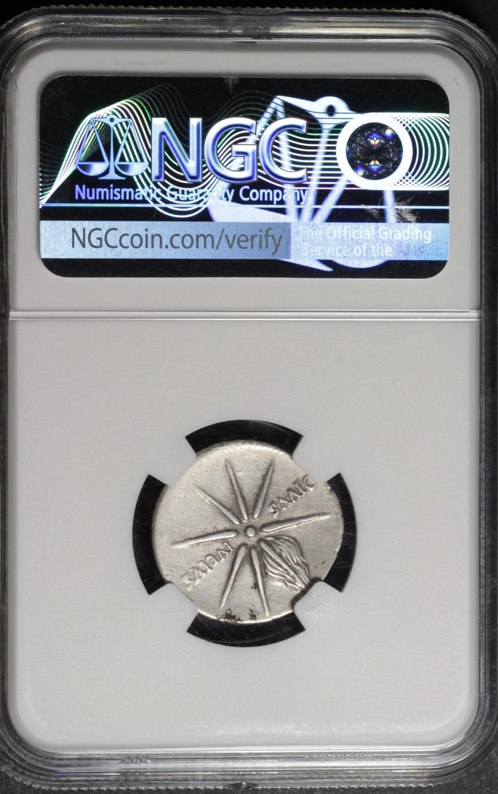 Silver coin with star design in a protective holder, featuring NGC logo.